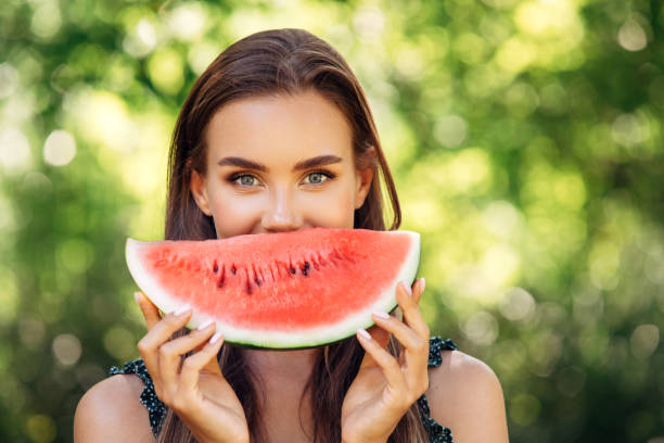istock Enjoying sunny day wile eating watermelon 1253730512