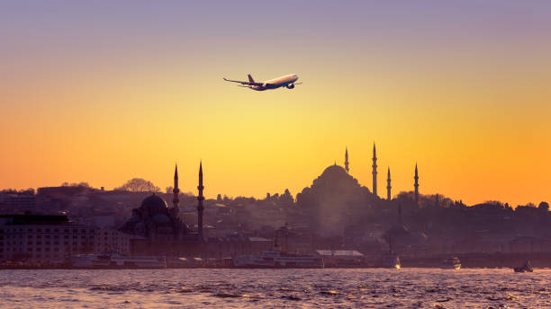 Istanbul at sunset with a passenger airplane.