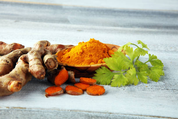istock Turmeric powder and fresh turmeric on grey background 1253730671