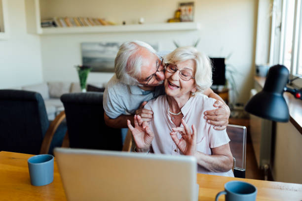 istock Happy elderly couple having fun at home 1253730699