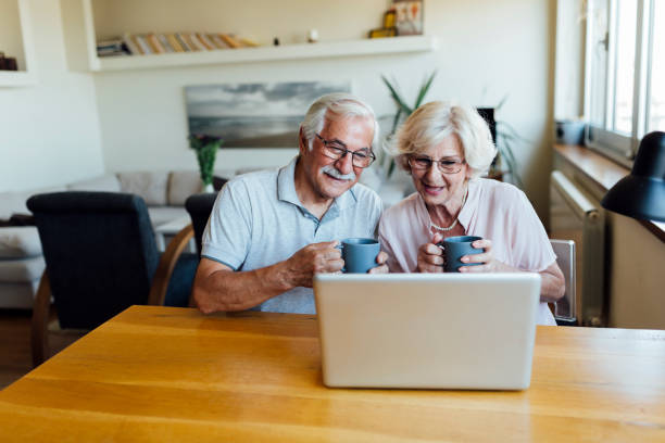 istock Happy elderly couple having fun at home 1253730700