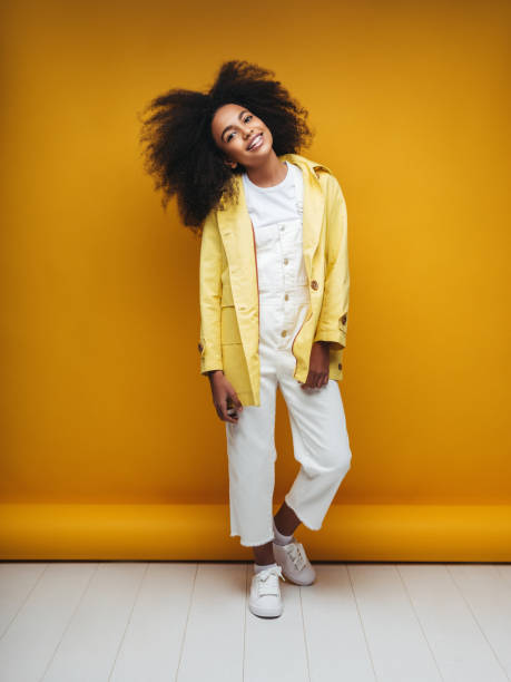 istock Young woman wearing raincoat 1253731412