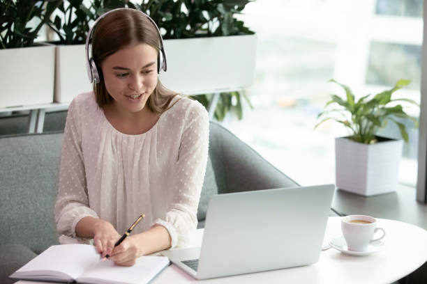 istock Woman in headphones communicate video calling 1253731465