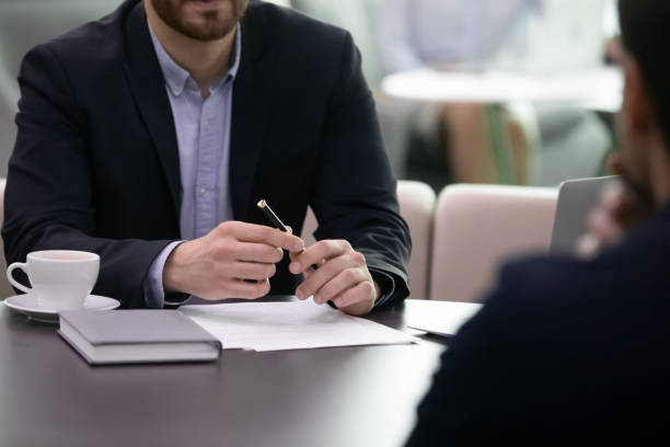 istock Close up of business advisor making notes while meeting client 1253731507