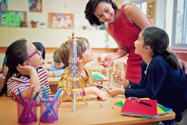 istock Teacher and school kids are working with metal construction set in a classroom 1253732550
