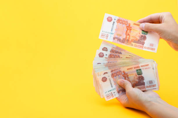 istock Hands count the amount in a pack of five thousandth bills 1253733641