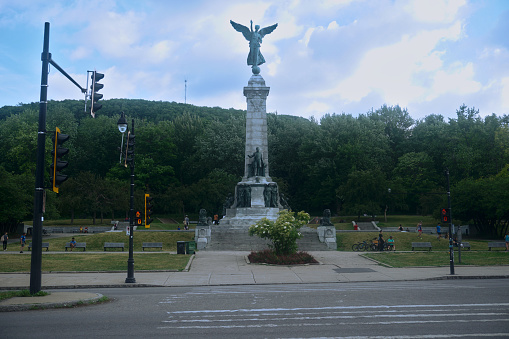Montreal, Quebec / Canada - 6/30/2020: Monument of Sir Georges Etienne Cartier, Mount Royal Parc Avenue. \nArtist: George William Hill, \nMaterial: Bronze, Stanstead granite,\nWidth: 8.75 metres (28.7 ft),\nHeight: 30.78 metres (101.0 ft),\nBeginning date: 1913,\nCompletion date: 1919.