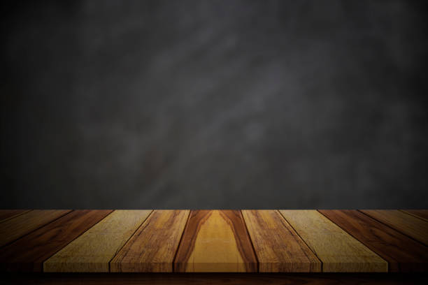 istock Empty wood table top over blur blackboard background. 1253739297
