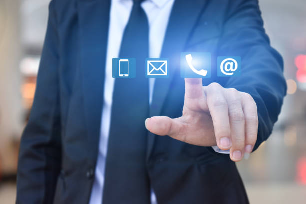istock CONTACT US. Businessman hand pressing icon 1253739526