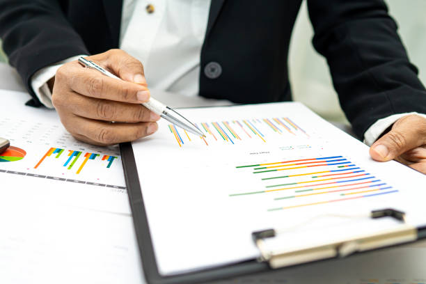 istock Asian accountant working and analyzing financial reports project accounting with chart graph and calculator in modern office,finance and business concept. 1253740433