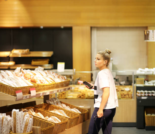 istock Woman choosing bread at supermarket 1253745567
