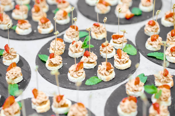 istock lots of canapes on black trays on a white table 1253762022
