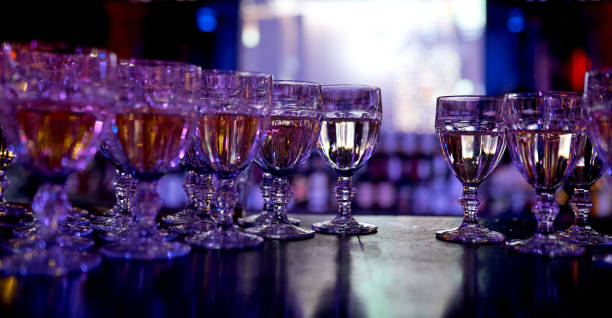 istock lots of wine glasses filled with drinks with one empty seat 1253762026