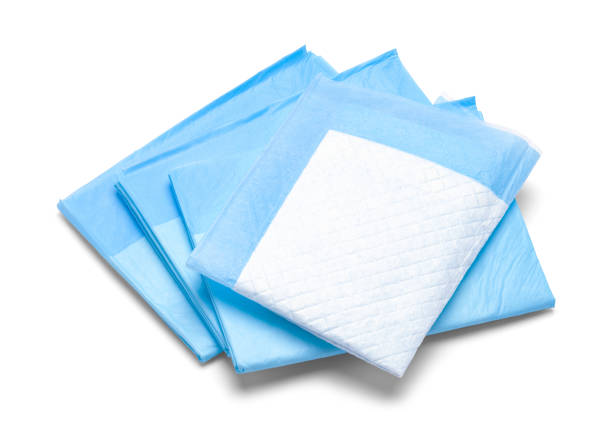 Pee Pads Stack of Blue Diaper Pads Isolated on White Background. incontinence stock pictures, royalty-free photos & images