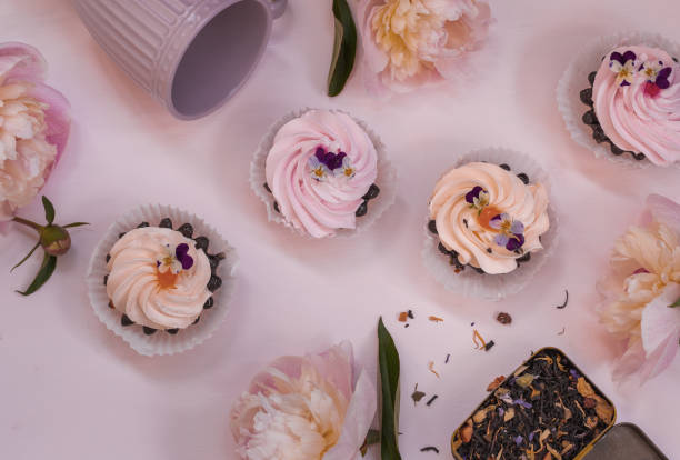 istock Pink peonies, cream cakes and flower tea 1253777962