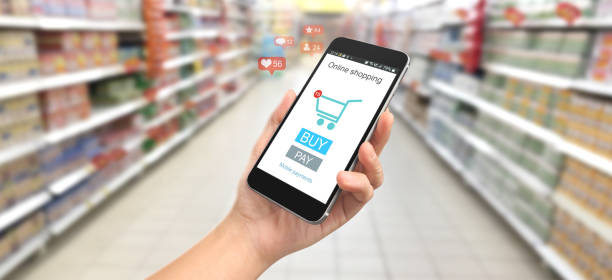 istock Man hand holding smartphone device and touching screen. Online shopping 1253781948