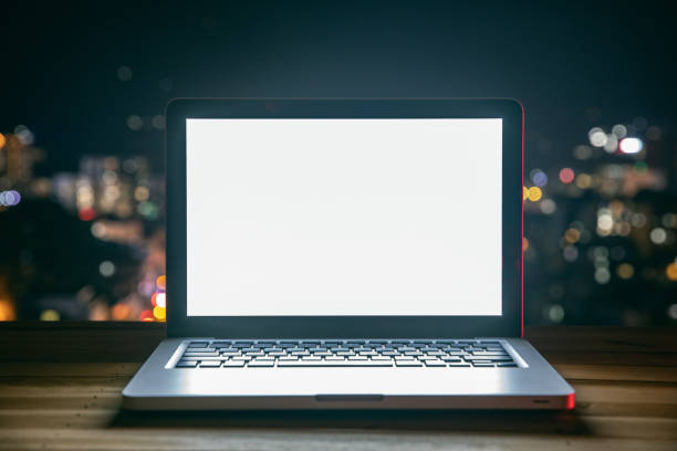 istock Laptop on table at night city 1253792668