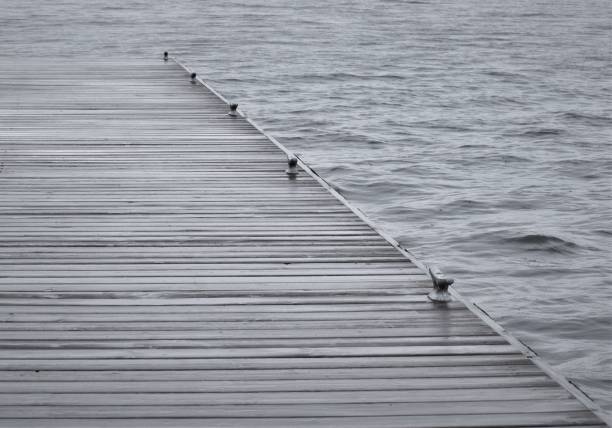 Wet dock with in stormy lake.  Strong diagonal lines.