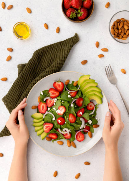 Salad with strawberry, avocado, onion, cheese and spinach