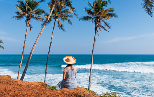 Female tourist visiting Coconut tree hill tropical wanderlust inspiration spot in Mirissa Sri Lanka