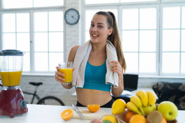 istock Young woman making detox smoothie at home 1253800964