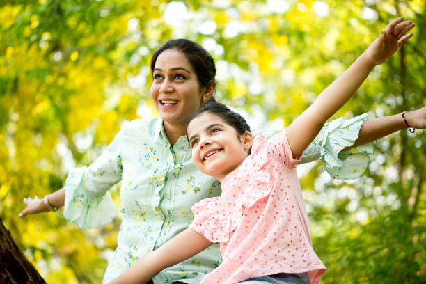 istock Happy mother and daughter at park 1253801643