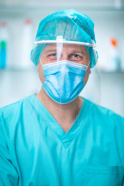 istock Doctor wearing protective face mask and visor with positive attitude 1253804875
