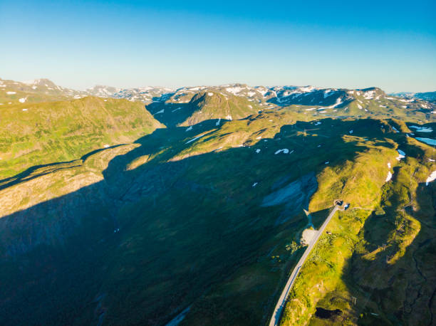 istock Road with tunnel in mountains Norway. Aerial view. 1253808568