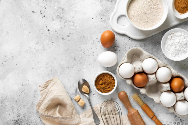 istock Ingredients for baking on a culinary background. Eggs, flour, cinnamon, sugar, soda on the kitchen table. Concept of preparation for baking. Top view with space for text 1253809620