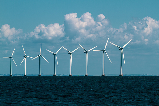 Wind turbines in the ocean just outside Copenhagen, Denmark. This wind farm is iconic for Copenhagen, as these can be viewed at distance from many sites in the city and from flights that transit in CPH.