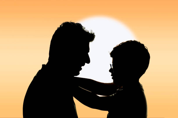 Silhouette of a happy father and son