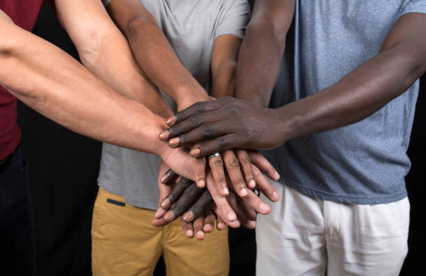 istock Group of men putting their hands together 1253811986