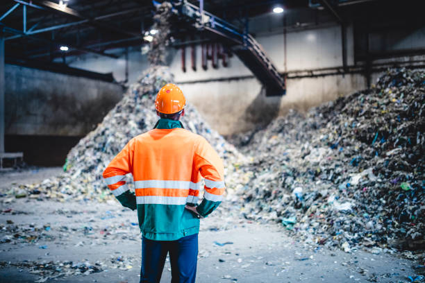 istock Male Worker in Protective Gear at Waste Processing Facility 1253813474