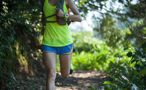istock Woman ultra marathon runner running on forest trail 1253815002