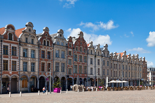 Arras, France - June 22 2020: Flamboyant Gothic buildings with Flemish gables and arcades along the Place des Héros in the city center.