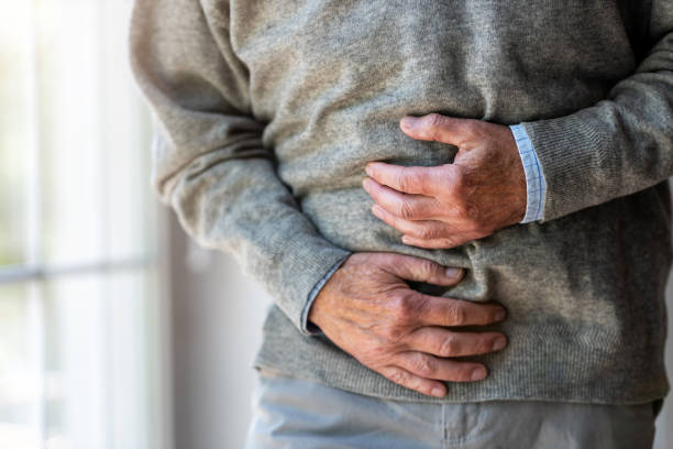 Senior man with stomach pain Senior man with stomach pain food poisoning photos stock pictures, royalty-free photos & images