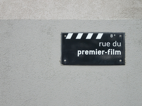 This is a street sign for the street where the very first moving picture image was created by the Lumiere brothers. As it literally translates 'Road of the first film'