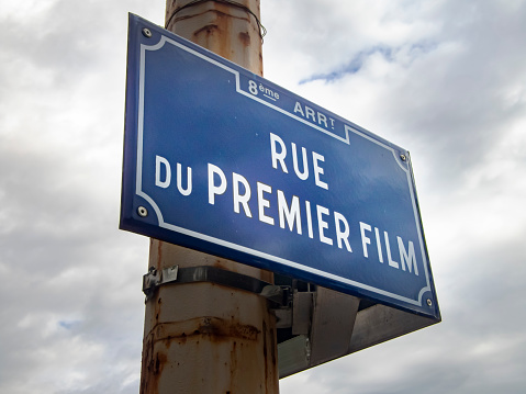 This is a street sign for the street where the very first moving picture image was created by the Lumiere brothers. As it literally translates 'Road of the first film'