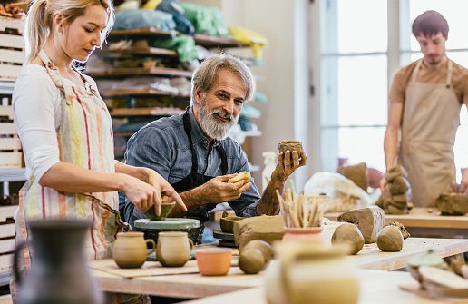 People making pottery in art studio