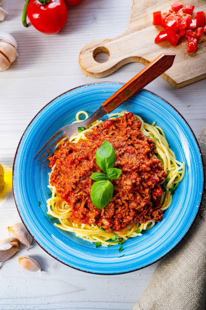 istock Delicious spaghetti bolognese on white background 1253819158