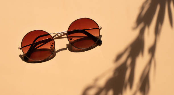 istock Brown sunglasses in a round shape. Bright sunlight. 1253819815