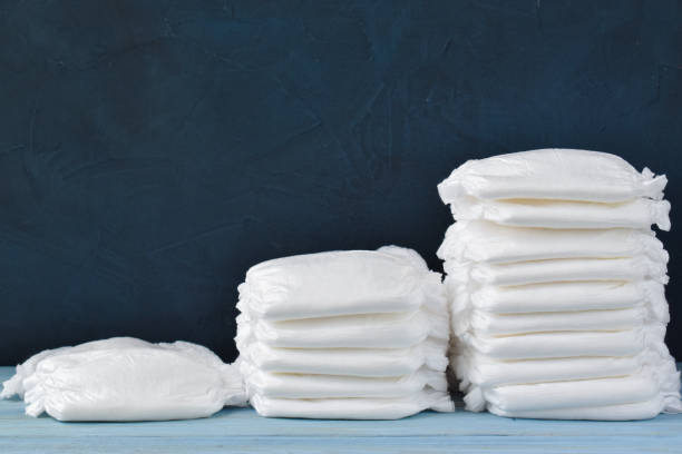 istock Three stacks of diapers on a blue background with copy space 1253821188