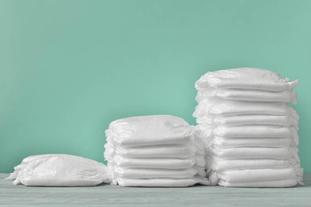 istock Three stacks of diapers on a turquoise background with copy space 1253821201