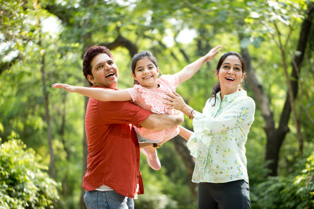 istock Parents lifting daughter and helping her fly 1253822450