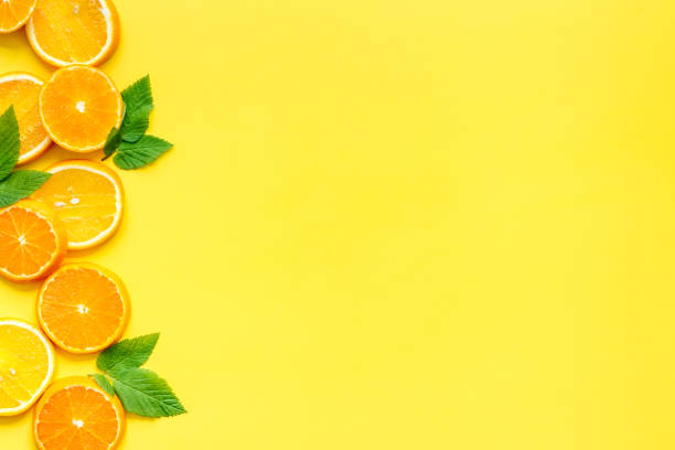 istock Sliced citrus fruits on yellow background top view 1253822561