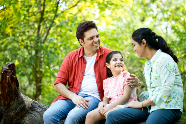 istock Happy family at park 1253822680