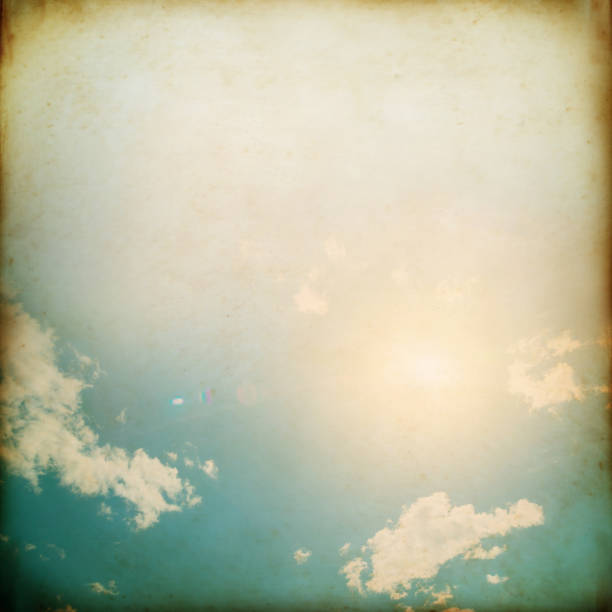 istock Grunge Sky paper with clouds and sun reflection 1253823289