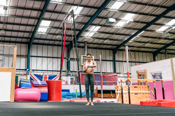 istock Strong female gymnast checking smart watch before workout 1253823308
