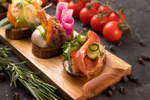 istock Assorted bruschetta with meat, cheese, micro green cooked by a catering company 1253823322