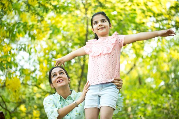 istock Happy mother and daughter at park 1253823382